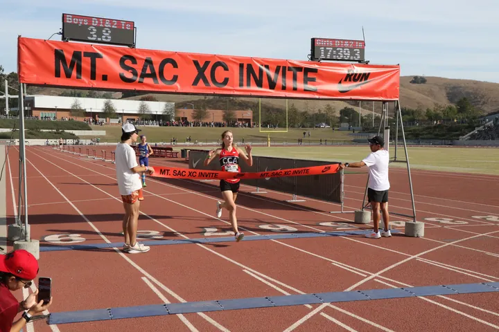 Two race clocks above the finish banner at the Mt. SAC XC Invite
